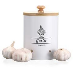 three garlics are sitting next to a canister with the lid open on it