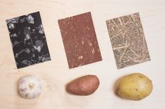 four different types of food are laid out on a wooden surface, including potatoes and garlic