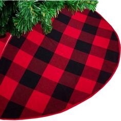 a red and black checkered christmas ornament hanging from a green tree branch