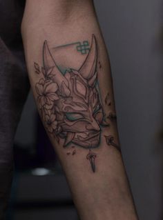 a man with a tattoo on his arm has a bull's head and flowers