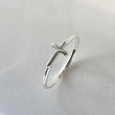 *  Perfect gift idea for any occasion: birthday, anniversary, engagement, graduation, bridesmaid, Mother's Day, Valentine's Day, Christmas, promise. *  Sterling Silver Tiny Sideway High Polish Cross Ring, Dainty Ring, Silver Ring, Statement Ring, Love Ring, God Ring, Religious Ring. Face Height: 5 mm Finish: High Polish Material: 925 Sterling Silver *  Your purchase includes a gift box come. Let us know if this is a gift and we can ship directly to the recipient and include a personalized note. Adjustable Cross-shaped Ring For Anniversary, Minimalist Adjustable Cross Ring, Minimalist Cross Ring For Anniversary, Minimalist Cross Rings For Gifts, Hypoallergenic White Gold Midi Rings As Gift, Adjustable Cross-shaped Promise Ring, Adjustable Simple Design Midi Ring As Gift, White Gold Cross Ring Gift, Adjustable Stackable Rings With Simple Design As Gift