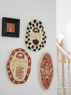 there are three decorative plates on the wall