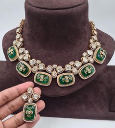 Sabyasachi's Inspired Emerald Polki Necklace is a breathtaking showcase of green Kundan and Polki jewelry, characterized by its exquisite craftsmanship. This necklace embodies the elegance of uncut Polki diamonds and seamlessly combines them with traditional Jadau and Kundan work. The rich green hues of the emeralds enhance the regal allure, making it a timeless piece. This necklace is a harmonious blend of tradition and contemporary aesthetics, celebrating the opulence of Polki and Kundan jewel Designer Green Jewelry For Formal Occasions, Traditional Pista Green Jewelry For Wedding, Designer Green Jewelry For Gifts, Designer Green Jewelry As Gift, Designer Green Jewelry As A Gift, Green Temple Necklace For Festivals And Reception, Green Kundan Bridal Necklace Hand Set, Designer Kundan Necklace For Weddings And Festivals, Green Necklace For Formal Festivals