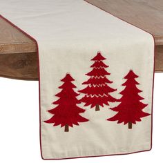 a table runner with red trees on it