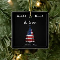 a christmas ornament hanging from a tree with the words grateful and free on it