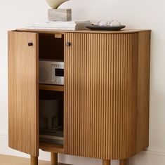 a wooden cabinet with a bowl on top of it