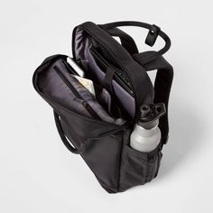 Get from point A to B with your style intact when you sport the Commuter Backpack from Open Story™. Simple and streamlined with space for what you need, it has a dedicated laptop compartment, an exterior zip pocket with swivel key holder, a large interior compartment and an elastic side pocket perfect for keeping your water bottle or umbrella close at hand. This tote-style backpack can be carried two ways or slipped over a suitcase handle for versatility that moves with you throughout your day — Mom Backpack, Elite Backpack, Stylish Luggage, Square Backpack, Commuter Backpack, Suitcase Handle, Work Backpack, Simple Backpack, Flap Backpack