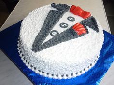 a white cake with black and red decorations