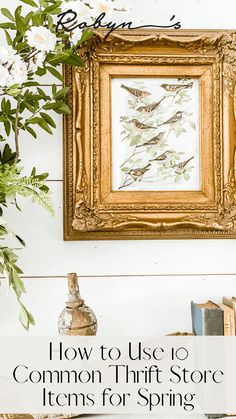 a painting hanging on the wall next to a vase with flowers and books in it