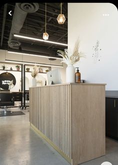 the reception desk is made from plywood and has gold trimmings on it