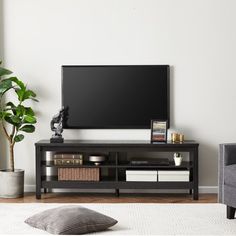 a flat screen tv sitting on top of a black entertainment center