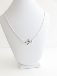 "This silver bird necklace is made with a tiny antiqued silver bird connector and silver plated chain. This delicate and feminine necklace will help you show off your love of nature and vintage inspired jewelry. ♥ Your choice of length ♥ Antiqued silver bird ♥ Silver plated chain ♥ Lobster claw clasp ♥ Nickel and lead-free Choose your favorite length and I'll make a little bird necklace just for you. Choose a shorter length to layer this sparrow necklace with your other favorite necklaces for a Sterling Silver Bird Necklace, Silver Bird-shaped Sterling Silver Necklace, Sterling Silver Necklace With Bird Design, Silver Sterling Silver Necklace With Bird Design, Sparrow Jewelry, Sparrow Necklace, Cottagecore Necklace, Silver Bird Necklace, Necklace Length Chart