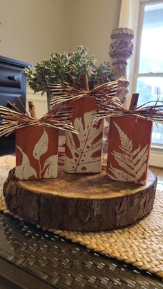 three wooden boxes with plants on them sitting on a table