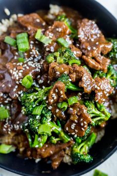 beef and broccoli with sesame seeds in a bowl