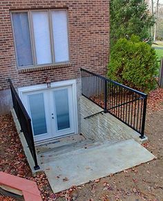 a screen shot of a house with an open front door and stairs leading up to it