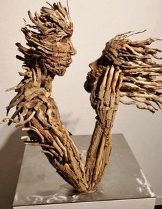 a sculpture made out of branches on top of a table