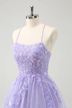 a dress on a mannequin with purple flowers