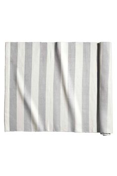 the grey and white striped towel is folded up