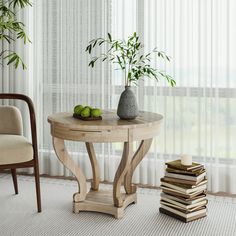 a table with some fruit on it next to a stack of books and a chair