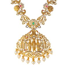 Virani Jewelers presents this stunning 22k gold and gemstone necklace, a timeless expression of beauty and grace. Crafted with precision and elegance, this long Indian gold necklace features a captivating array of emeralds, rubies, cubic zirconia, and pearls. The golden allure of 22k gold enhances the beauty of this gold temple necklace, creating a timeless piece of Indian gold jewelry that resonates with cultural heritage and refined taste. Features • 22k yellow gold • Ruby • Emerald • Cubic zi Festive 22k Yellow Gold Emerald Necklace, Yellow Gold Emerald Necklace For Festivals, Festive 22k Gold Emerald Necklace, Gold Emerald Necklace With Intricate Design For Celebration, Gold Emerald Necklace With Intricate Design For Festive Occasions, Gold Kundan Necklace With Gemstone For Spiritual Occasions, Gold Kundan Necklace With Gemstone For Spiritual Events, Gold Kundan Necklace With Gemstones For Spiritual Use, 22k Gold Emerald Necklace For Festive Occasions