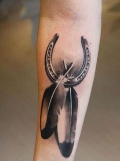 a black and white photo of a tattoo with an arrow on it's leg