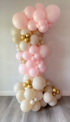 a bunch of balloons that are in the shape of a tower on top of each other