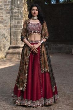 Maroon lehenga embellished with mirror, coin tassel hem and embroidery. Paired with embroidered blouse and ajrakh print dupatta.
Component: 3
Pattern: Embellished
Type Of Work: Mirror Work
Neckline: U-neck
Sleeve Type: Sleeveless
Fabric: Raw Silk
Color: Maroon
Other Details: 
Coin tassel details
Bead and thread work embroidery
Occasion: Wedding - Aza Fashions Maroon Blouse Lehenga, Lehenga Couture, Patola Lehenga, Designer Chaniya Choli, Navratri Outfits, Maroon Lehenga, Reuse Ideas, Mehendi Outfit, Desi Fits