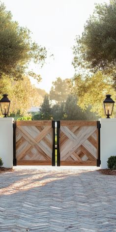 a wooden gate with two lights on each side