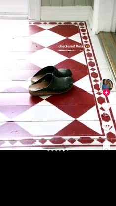 a pair of shoes sitting on top of a red and white checkerboard floor