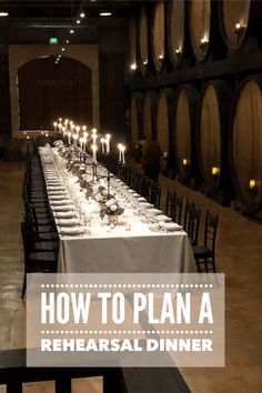 a long table is set up with wine barrels in the background and candles on top