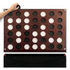 a giant four in a row game board with white and black dots on it's sides