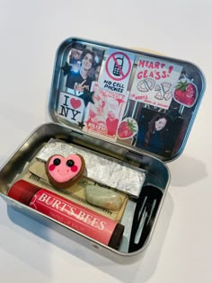 an open tin with various items in it