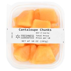 cantaloupe chunks in a plastic container on a white background