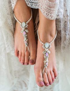 Luxurious, elegant, and just as refined as the perfect wedding ceremony, these bridal barefoot sandals have a rich Bohemian glamor.  An oh-so-romantic tint of pale pink warms up traditional white dresses - or matches the blush hues that suffuse today's most longed-for designer bridal gowns.  But while they're trend-conscious, these barefoot wedding sandals are timeless in their sparkle.  These high-end bridal anklets are gorgeously handcrafted from a range of fine Swarovski elements in three color variations.  With classic pearls looping the ankle and a stretchy, sturdy fit so your steps are graceful, this accessory makes your destination wedding dreamier than ever. Photo: Julija Erina  Wedding Dress: Katya Katya Shehurina Barefoot sandals: Olga Barmine Mua: Karina Frantsuzova Hair: Kateri Silver Toe Ring Barefoot Sandals For Destination Wedding, Elegant Adjustable Barefoot Sandals With Toe Ring, Elegant Adjustable Toe Ring Barefoot Sandals, Elegant Silver Beaded Barefoot Sandals, Silver Beaded Anklets For Destination Wedding, Elegant Summer Wedding Jewelry, Summer Elegant Rhinestone Anklets, Elegant Silver Toe Ring Barefoot Sandals, Elegant Barefoot Sandals With Ankle Strap As A Gift