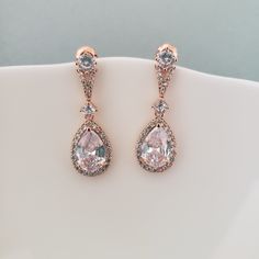 Dainty romantic drop earrings. Clear zircon stones set in rose gold plated metal The earrings are about 1 3/4 inches long.  Very bright and sparkly.  Please contact me if you have any questions. Swarovski Crystal Drop Earrings, Gold Leaf Pendant, Pearl Cuff Bracelet, Bridesmaids Jewelry, Rose Gold Bridal, Rose Gold Chain, Knot Earrings, Necklace Crystal, Rose Gold Metal