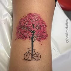 a woman's arm with a tree and bicycle on it