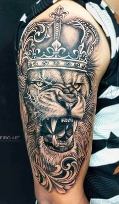 a lion with a crown on his head is shown in black and grey tattoo art