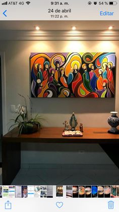 an art piece is displayed on the wall above a table