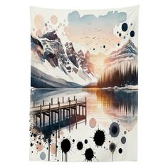 a wall hanging tapestry with an image of mountains and a pier in the water at sunset