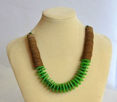 "Green beaded necklace - this green statement necklace will upgrade your outfit with color and style. This sustainable paper bead avant-garde necklace is a unique handmade recycled jewelry piece. This avant-garde necklace is made of recycled circular book & green paper disc beads separated by green-colored wood beads. This chic bohemian necklace is impossible to ignore, and the fact that it is hand-made of recycled paper beads gives it that extra meaningful glamour. All my jewelry is 100% handma Unique Green Necklaces With Wooden Beads, Unique Green Wooden Beaded Necklaces, Green Wooden Beaded Necklaces, Beaded Necklace Green, Paper Bead Necklace, Green Statement Necklace, Paper Beads Necklace, Green Beaded Necklace, Unique Handmade Gifts