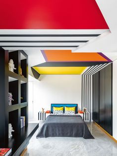 the bedroom is decorated in black, white, and orange colors with an unusual ceiling