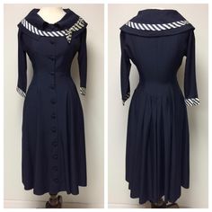 A 1950's navy day dress, very chic! They used the reverse side of a sateen fabric. A dolman 3/4 sleeve, rolled collar, with navy and white diagonal striped trim on the collar and cuffs with an off set bow on the collar. There are 8 princess panels. At the back, below the waist are 6 pleats for extra fullness. The front closure is 12 covered buttons. There are 2 side pockets. No label. No damage to the fabric. The dress has been dry cleaned. Measurements:      Shoulder to shoulder, estimate: 15"      Cuff-cuff: 46 1/2"      Bust: 36 3/4"      Waist: 25 3/4"      Hips: Free      Front shoulder to hem: 43"      Skirt circumference: 113"      Cuff circumference: 10" I don't accept returns, so feel free to ask any questions you may have, or for more photos. Navy Fitted Vintage Dress, Vintage Semi-formal Dresses With Button Closure, Vintage Semi-formal Dresses With Buttons, Semi-formal Vintage Dresses With Button Closure, Retro Semi-formal Dresses With Buttons, Fitted Navy Dress With Buttons, 1950s Style Formal Dress With Button Closure, Navy Vintage Dresses With Buttons, Navy Vintage Dress With Buttons