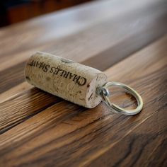 a cork keychain sitting on top of a wooden table