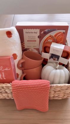 a basket filled with lots of items sitting on top of a wooden table next to a pillow