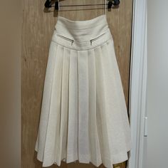 Chanel Pleated Lurex High-Waist Midi Skirt In Ivory Polyester (49%), Wool (43%) And Polyamide (8%) Mixed With Lilca Metallic Lurex Threads. Has An Iridescent Color To It From Threads. From Fall/Winter 2017 Collection. Skirt Has Two Faux Zipper Pockets At Front And Two Slits On The Side. Opens With A Zipper At The Back And Is Lined In Ivory Silk (100%). Is A Size 38 France Which Is Us Small/ Size 6. Exact Original Price Not Known But On Other Sites Sold For Upwards Of $4800.00. In Excellent Condi Chanel Label, High Waist Midi Skirt, Chanel Skirt, Iridescent Color, Skirts Midi High Waisted, Ivory Silk, Women Skirts Midi, Ivory Color, Cut Off