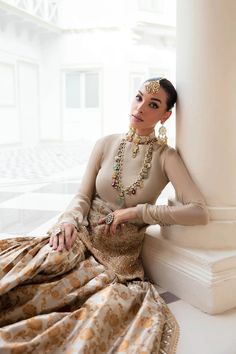 Classic Gold Embroidered Pakistani Wedding Dress Kameez Sharara Style is the perfect choice to make an appearance this festive season. A breathtaking Masoori chiffon short shirt stands as a testament to the harmonious fusion of art and class, enriched with opulent embellishments and meticulous Tilla hand-work. Embroidered Kameez: The traditional kameez Frock in the ivory shade is an exquisite masterpiece to wear on any wedding festivity. The beautiful Angrakha Dress is gracefully adorned with se Angrakha Dress, Gold Dupatta, Sharara Style, Pakistani Clothes Online, Pakistani Designer Clothes, Pakistani Wedding Dress, Chiffon Shorts, Traditional Indian Outfits, Short Shirt