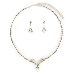 This jewelry set is stunning! It is encrusted with clear, sparkling rhinestones along a silver plate. The necklace measures approximately 15" long. The matching Earrings measure 1.0" long. It is perfect for weddings, proms, formals, parties, pageants, and more. It coordinates with any color or style wedding dress or formal ensemble. Silver Costume Jewelry Sets With Bling, Silver Bling Costume Jewelry Sets, Silver Costume Jewelry Sets With Rhinestones, Silver Metal Jewelry Sets With Bling, Silver Rhinestone Costume Jewelry Sets, Silver Jewelry Sets With Rhinestones And Cubic Zirconia, Silver Cubic Zirconia Jewelry Sets With Rhinestones, Silver Crystal Jewelry Sets With Diamond Accents, Silver Jewelry Sets With Diamond Accents