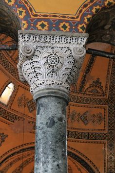 an ornate column in the middle of a building