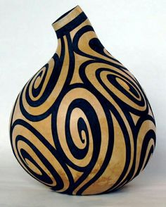 a black and gold vase sitting on top of a table