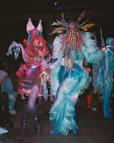 two people dressed up in costumes and masks